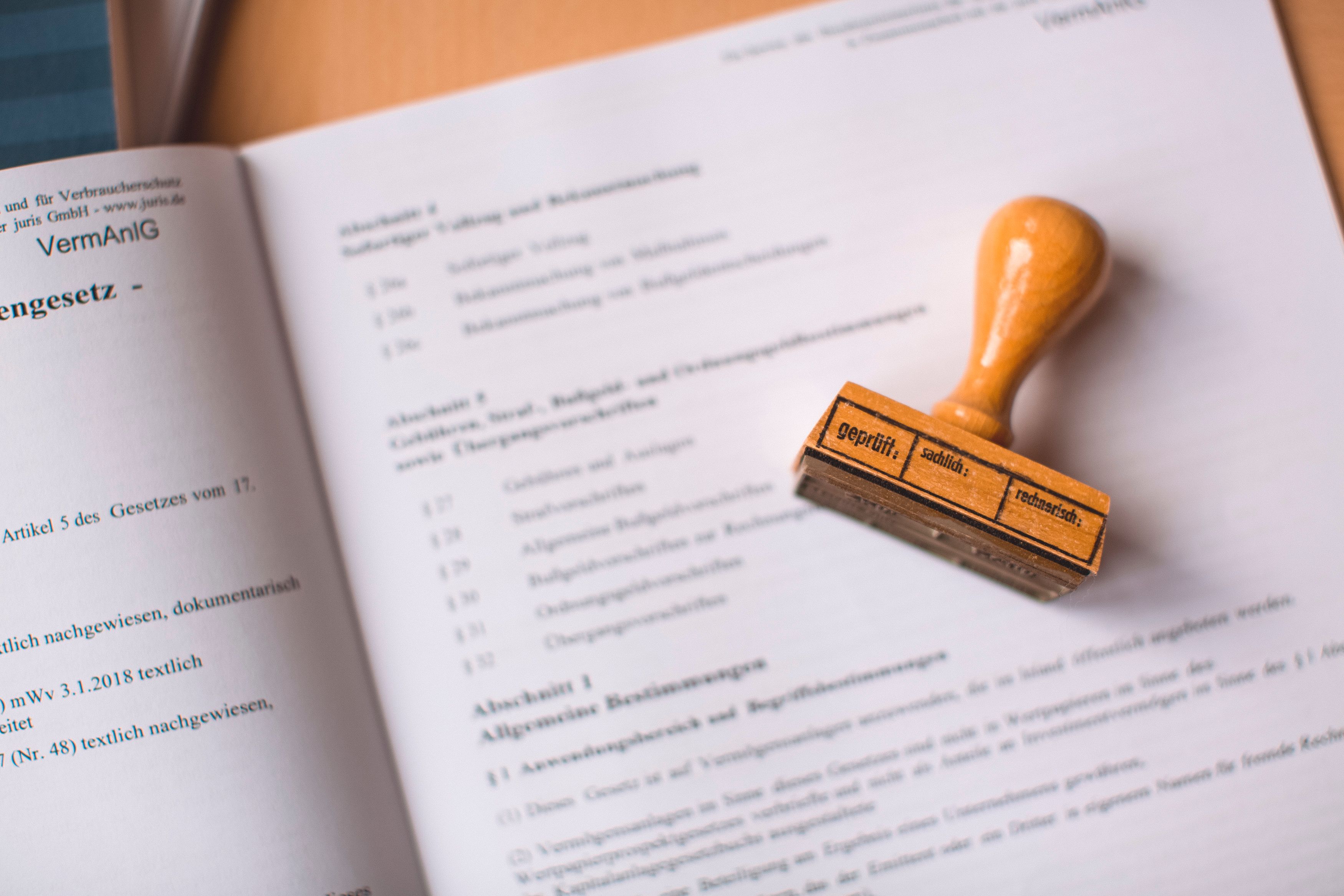 Close-up of a legal document with a wooden stamp highlighting civil claims verification