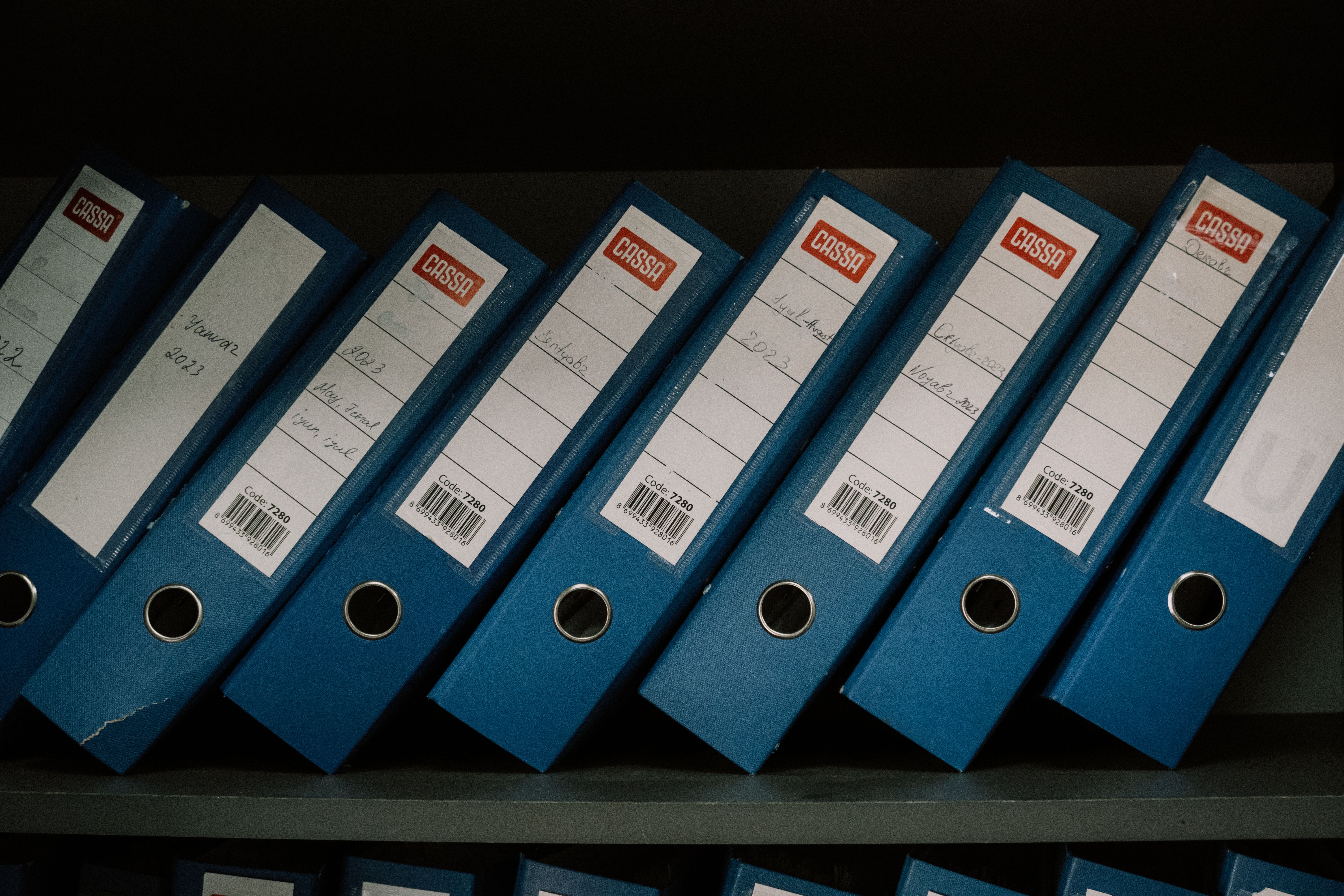 Neatly organized binders and case files representing management of large-scale civil claims