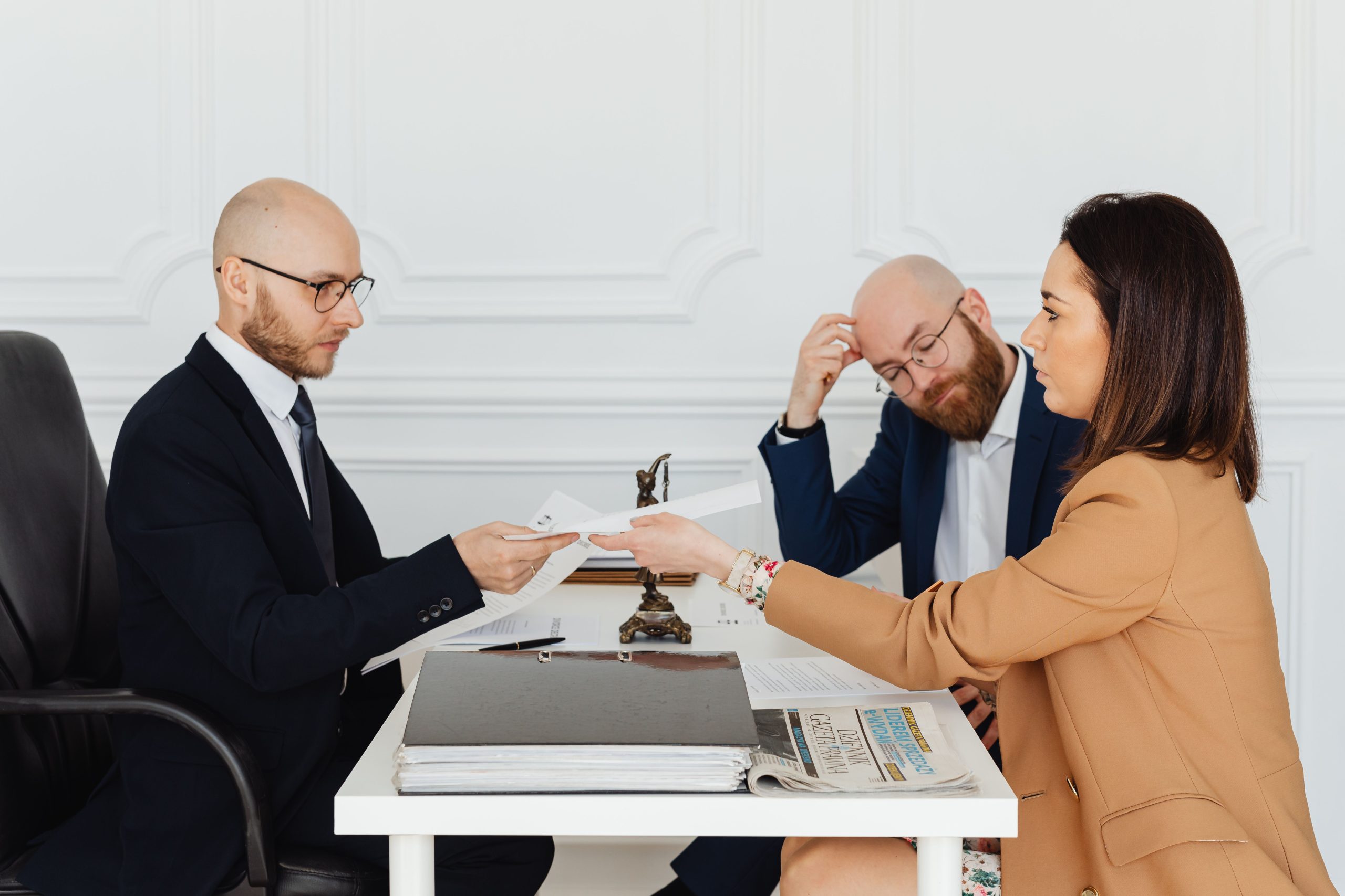 Legal team and clients reviewing documents for a large-scale civil claims case in a modern office